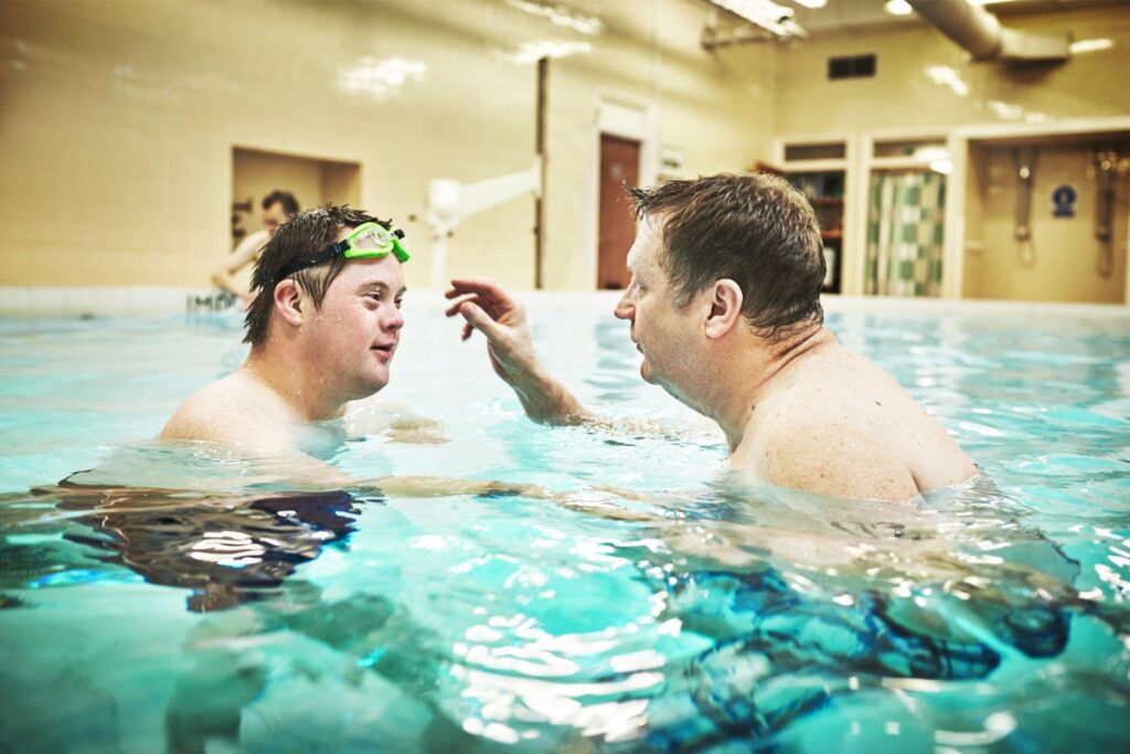 Coach teaches first swimming lesson to man with Down syndrome